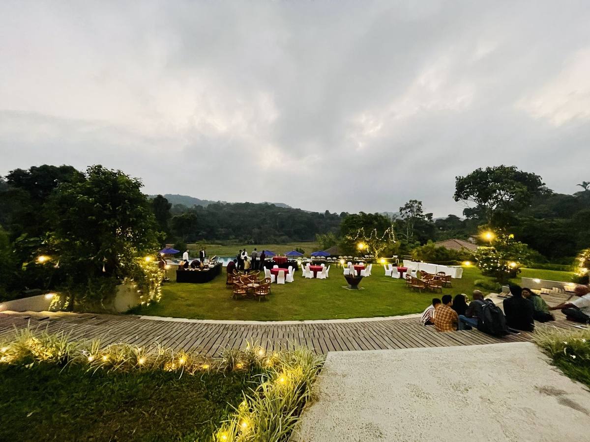 A lawn dinner set up at dusk for a company celebration